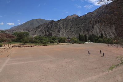 People playing soccer in the mountains