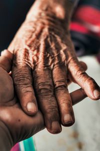 Cropped image of people holding hands