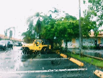 Cars on wet glass window during rainy season