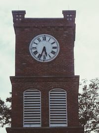 Low angle view of clock tower against sky