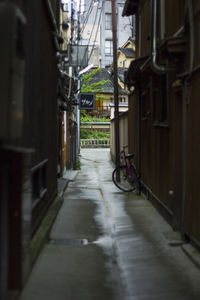 Empty alley amidst buildings in city