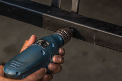 Close-up of hand drilling in metal