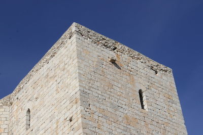 Low angle view of historical building against clear blue sky