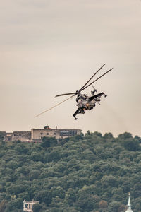 Low angle view of helicopter against sky