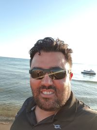 Portrait of young man against sea