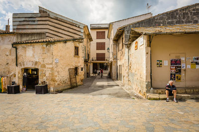 Street amidst buildings in city against sky