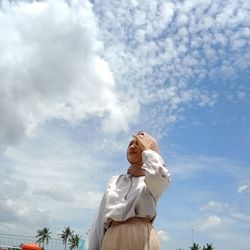 Low angle view of man sculpture against sky