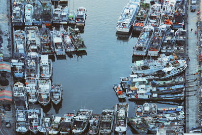 High angle view of boats moored at harbor