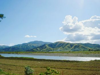 Scenic view of lake and mountains against sky