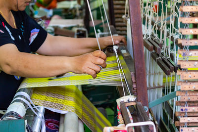 Midsection of woman working in textile industry