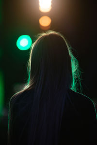 Silhouette of a girl in the background light at a concert
