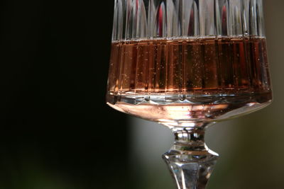 Close-up of wine glass against black background