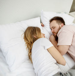 Young woman sleeping on bed