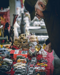 Midsection of man standing for sale at market stall