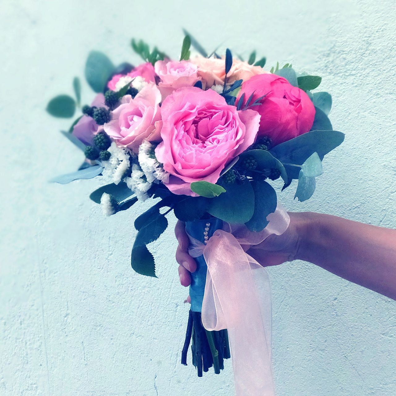 flower, freshness, fragility, holding, petal, bouquet, flower head, beauty in nature, person, rose - flower, indoors, part of, vase, close-up, bunch of flowers, botany, flower arrangement, nature, softness, personal perspective, springtime, rose, blossom, pink color, human finger, beauty, in bloom