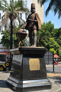 Low angle view of statue against trees