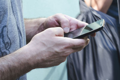 Close-up of man using mobile phone
