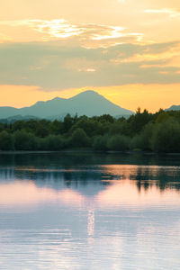 Scenic view of lake against orange sky