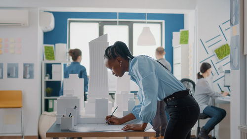 Side view of man working in office