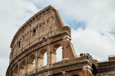 Low angle view of coliseum against sky