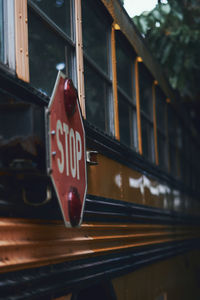 Low angle view of text on glass window of a school bus 