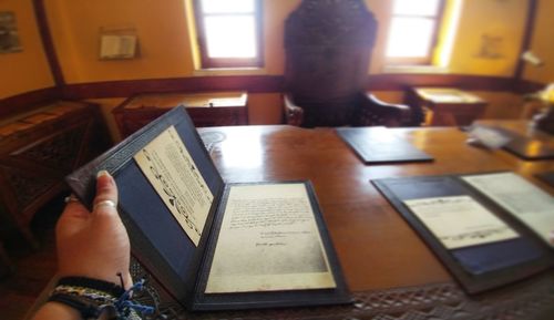 High angle view of man reading book on table