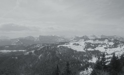 Scenic view of snow covered mountains against sky