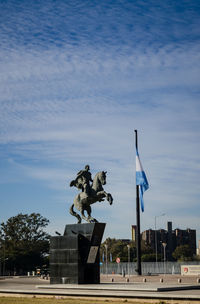 Statue against sky in city