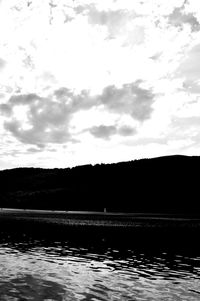 Scenic view of lake against cloudy sky