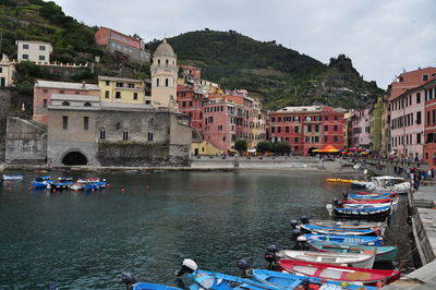 Boats in canal against buildings in city