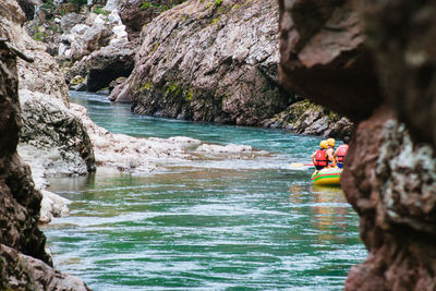 People on rock by river