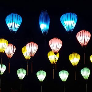 Low angle view of illuminated lanterns hanging at night