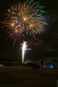 Low angle view of firework display at night