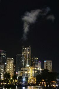 Low angle view of skyscrapers lit up at night