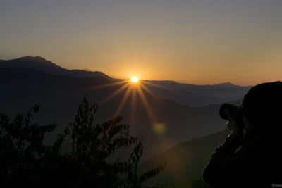 Scenic view of mountains against sky during sunset