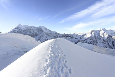 Scenic view of snow covered mountains against sky