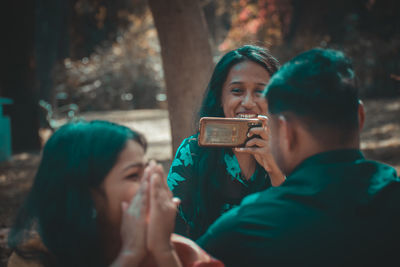 Portrait of woman photographing