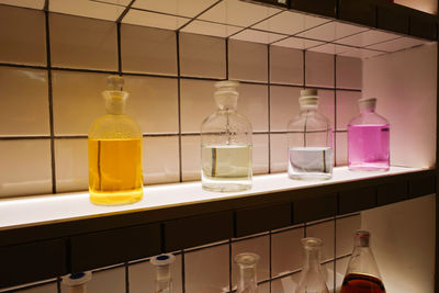 Glass bottles of different shapes with colorful liquids