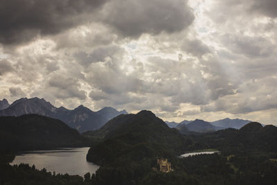 Scenic view of mountains against cloudy sky