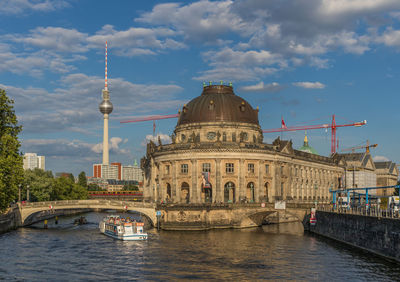 Bridge over river with buildings in background