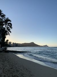 Scenic view of sea against clear sky at sunset