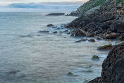 Scenic view of sea against cloudy sky