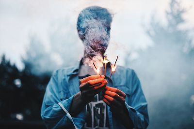 Full length of man holding cigarette