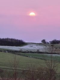 Scenic view of field against sky during sunset