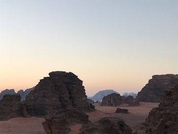 Rock formations against sky during sunset