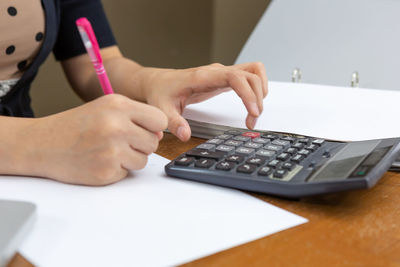 Midsection of woman working on table