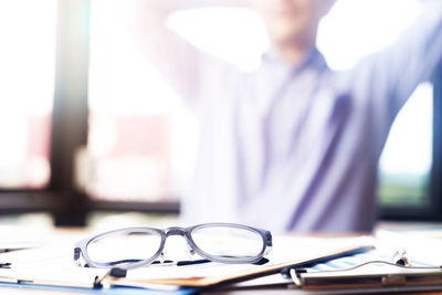 Midsection of businessman at desk in office