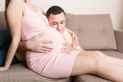 Young couple sitting on sofa at home