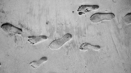 High angle view of footprints on sand at beach