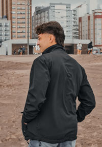 Rear view of man standing at beach